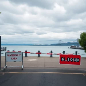 Signage and barriers at the entrance of Beaufort Waterfront Park indicating closure.