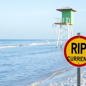Sunset at Hilton Head Beach with warning flags