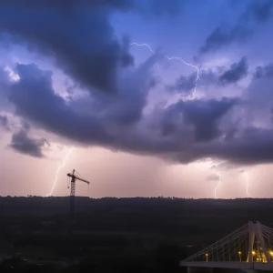 Stormy weather impacting traffic near a bridge with a crane