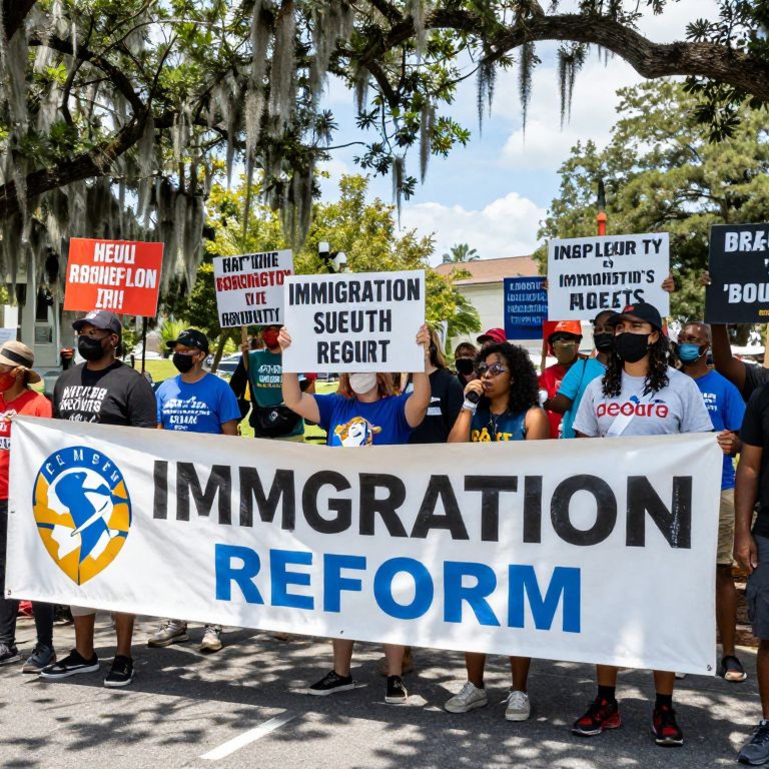 Protesters holding signs advocating against ICE policies in Beaufort, SC.