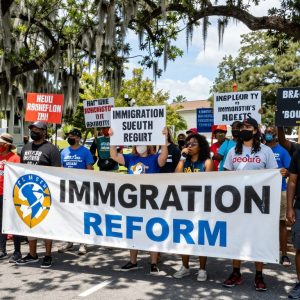 Protesters holding signs advocating against ICE policies in Beaufort, SC.