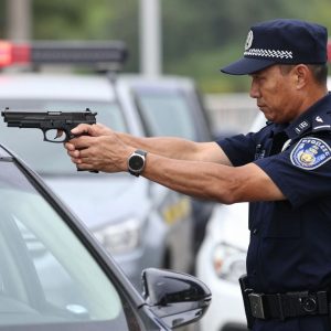 Police officer inspecting a firearm during a traffic stop