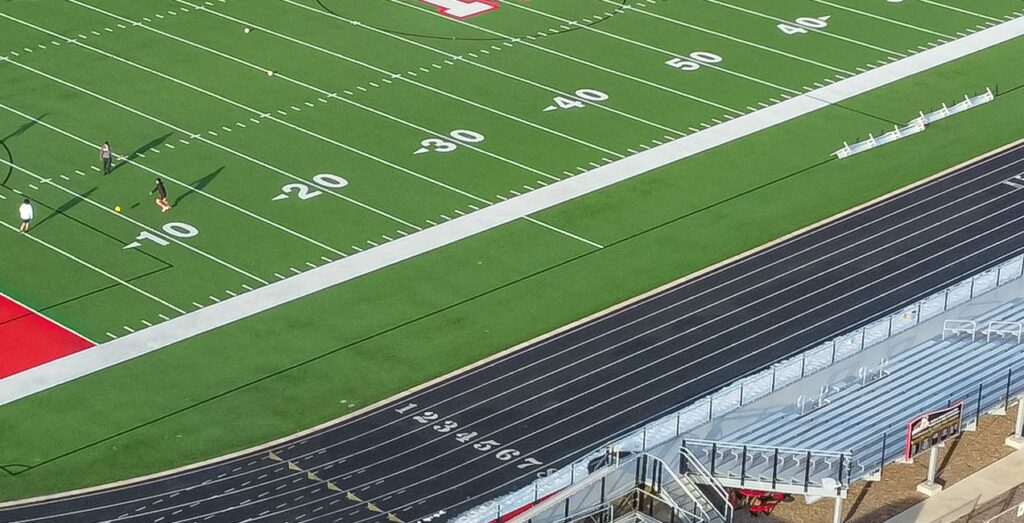 Football field yard numbers beside a running track